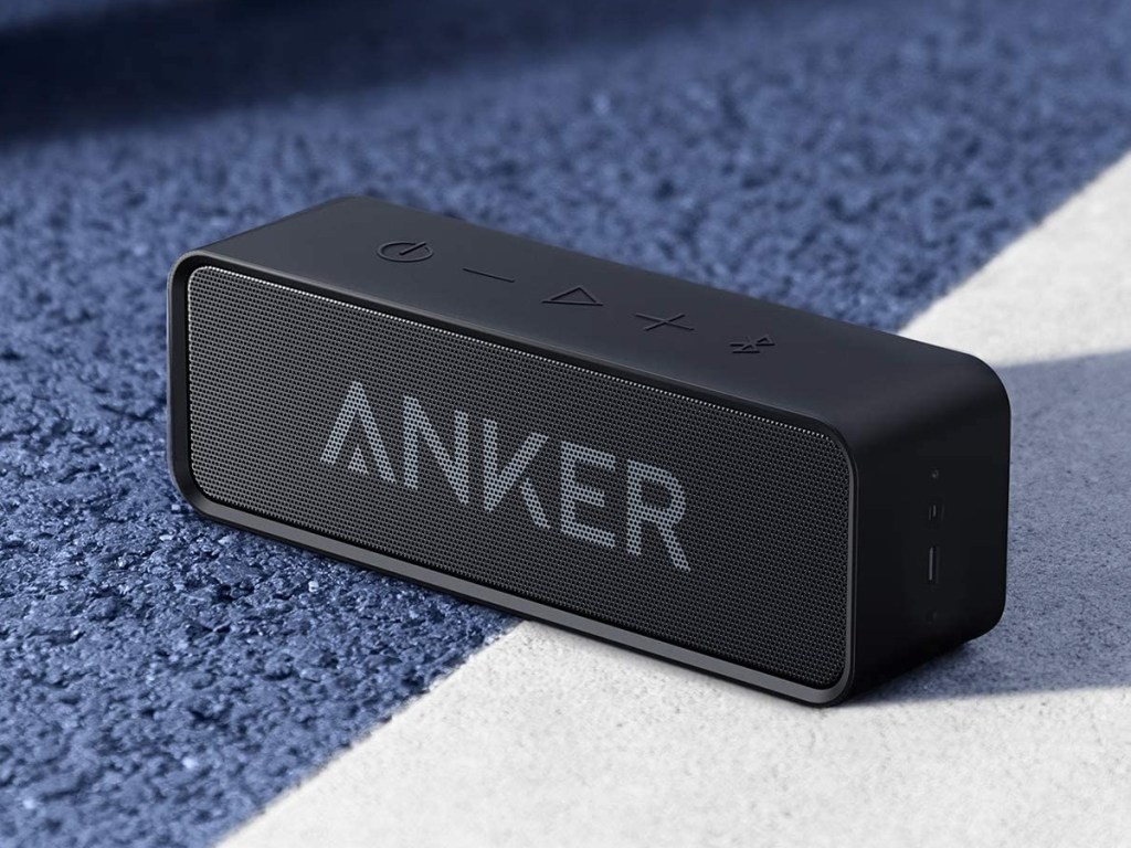 Anker bluetooth speaker on blue tennis court