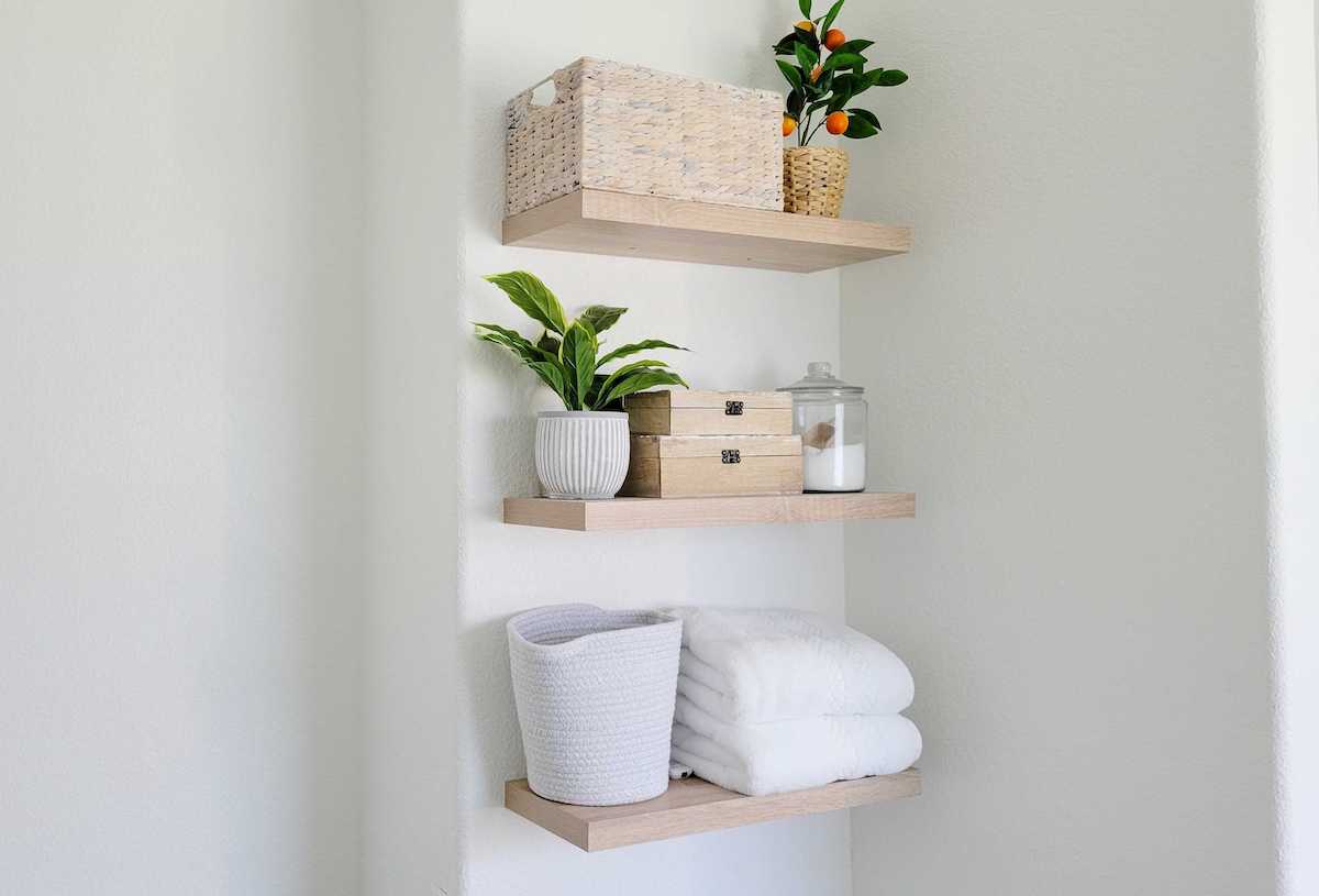 bamboo floating shelves on wall with bathroom decor