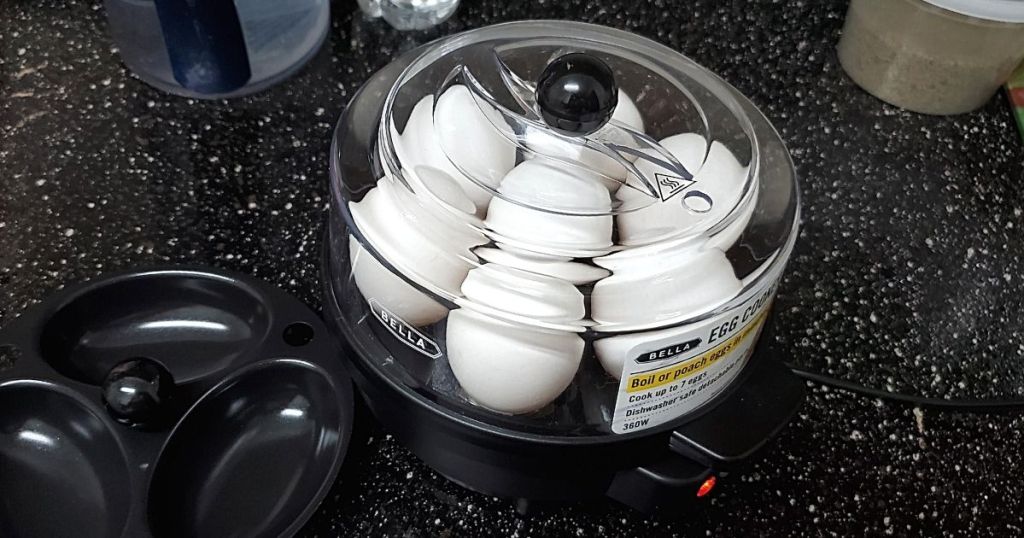 Bella egg cooker on countertop filled with eggs