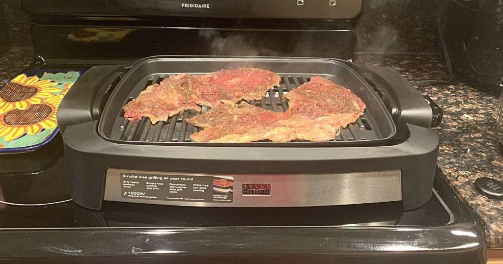 meat cooking on countertop grill