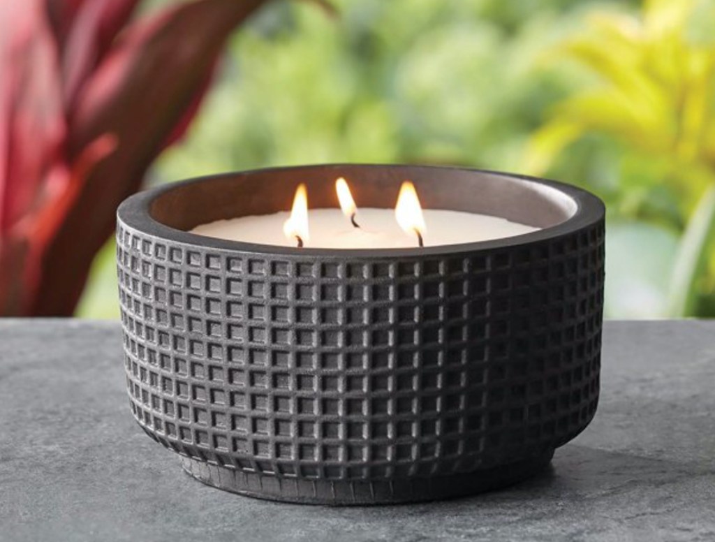 black citronella candle on table outside