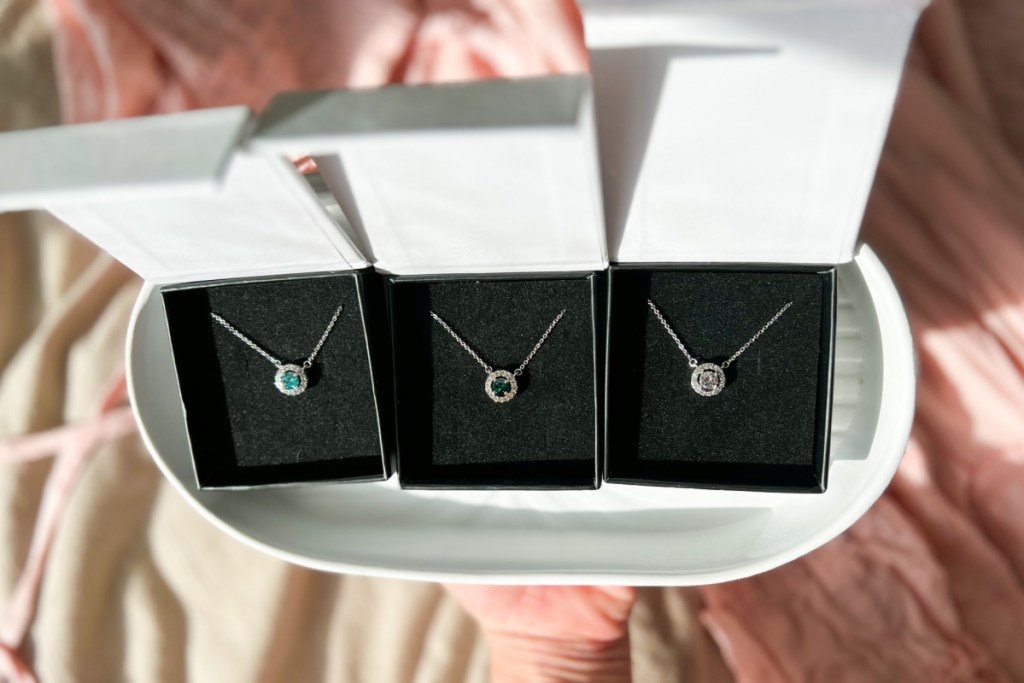 three birthstone necklaces in gift boxes
