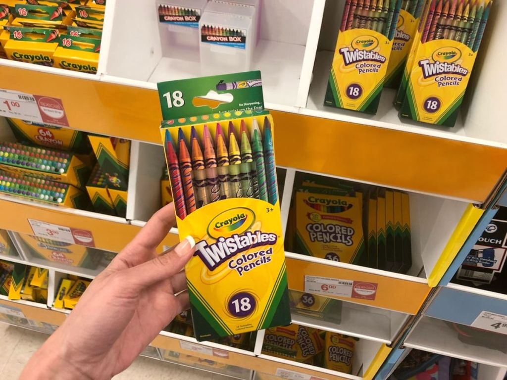 holding a package of Crayola Twistables