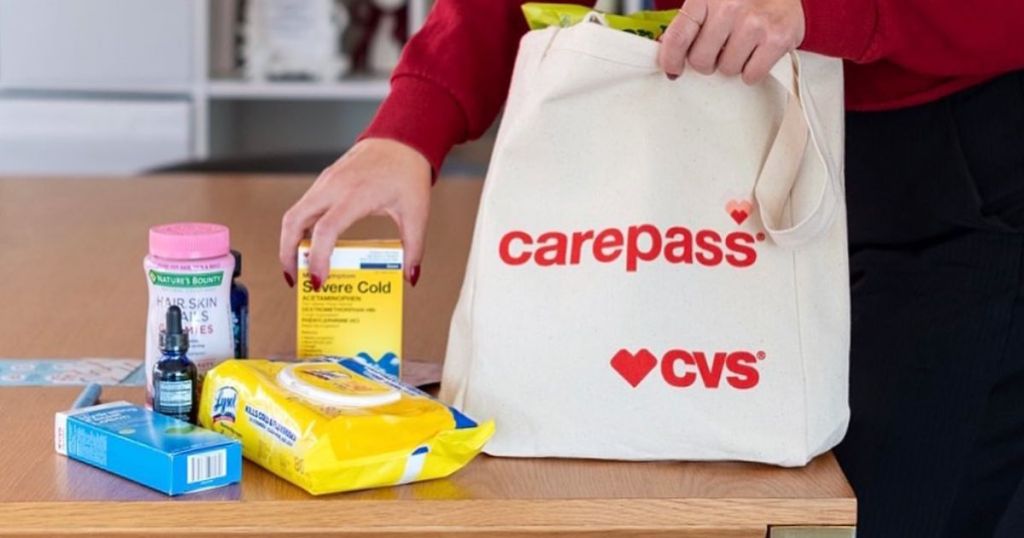 woman taking products out of carepass CVS tote bag