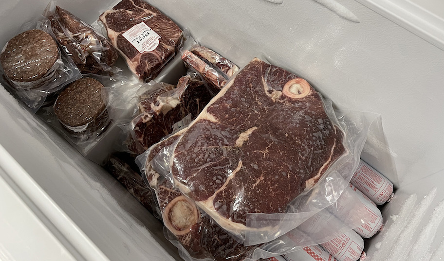 steaks and beef in white deep freezer chest