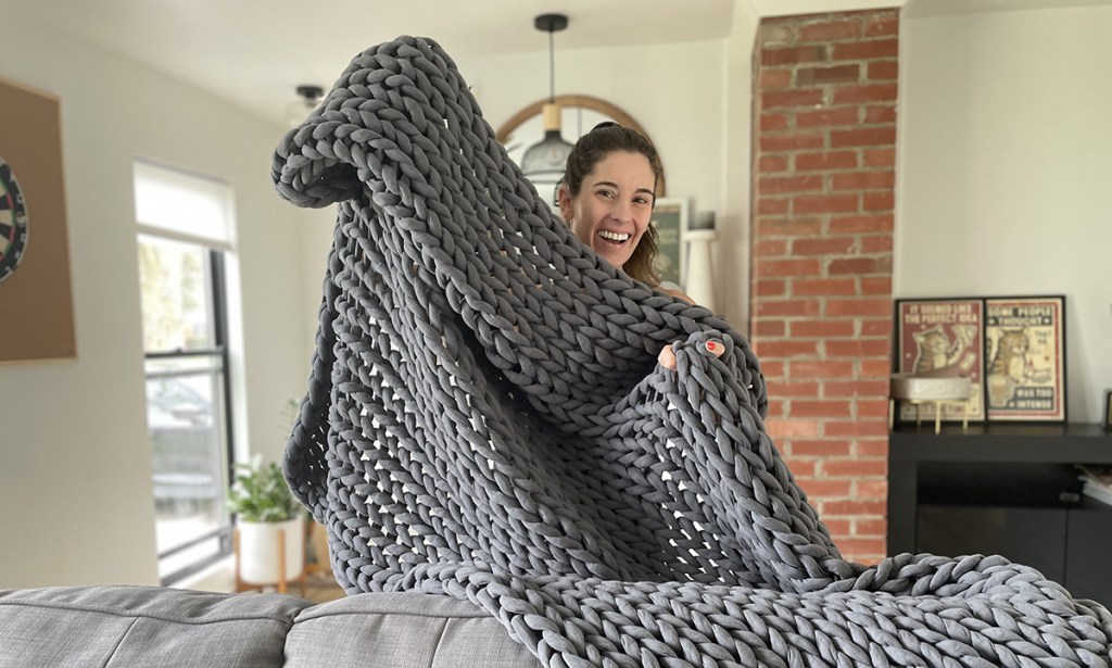 woman holding bearaby weighted blanket