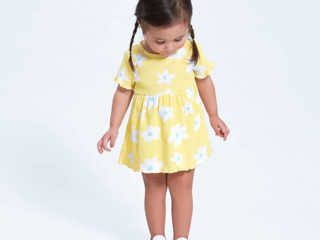 toddler girl wearing yellow and white floral dress