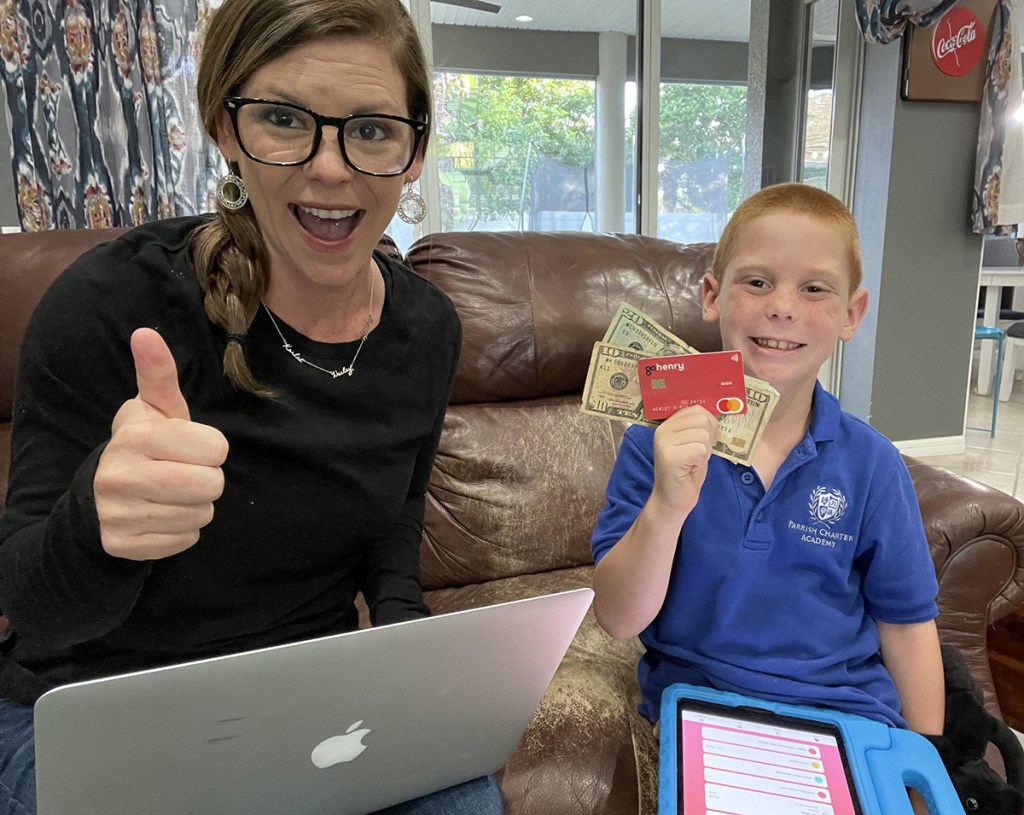 mom and son with gohenry debit card for kids