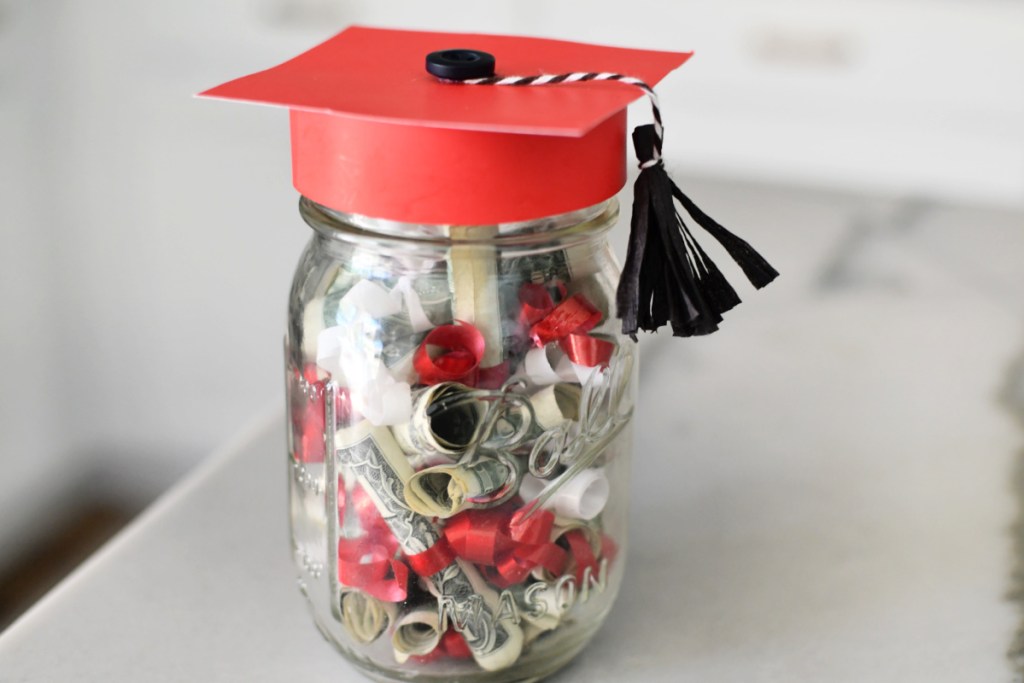 grad cap jar with money diplomas