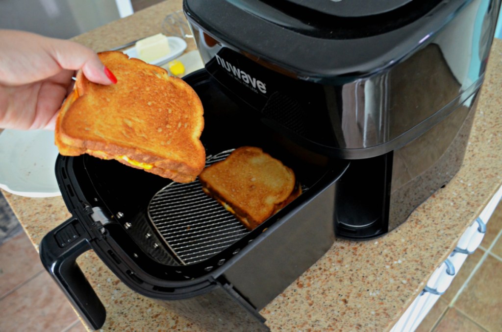 hand holding a grilled cheese air fryer sandwich