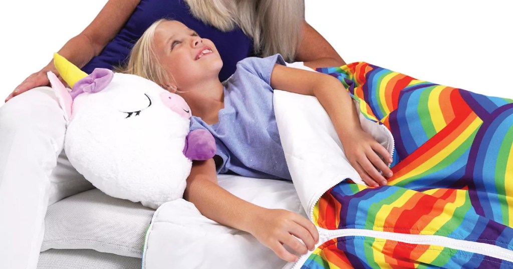 girl laying in a happy nappers unicorn