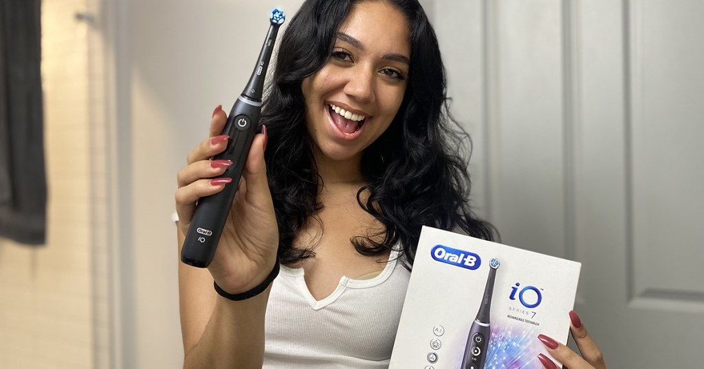 woman with oral b electric toothbrush