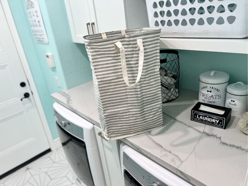 gray and white striped laundry basket on counter