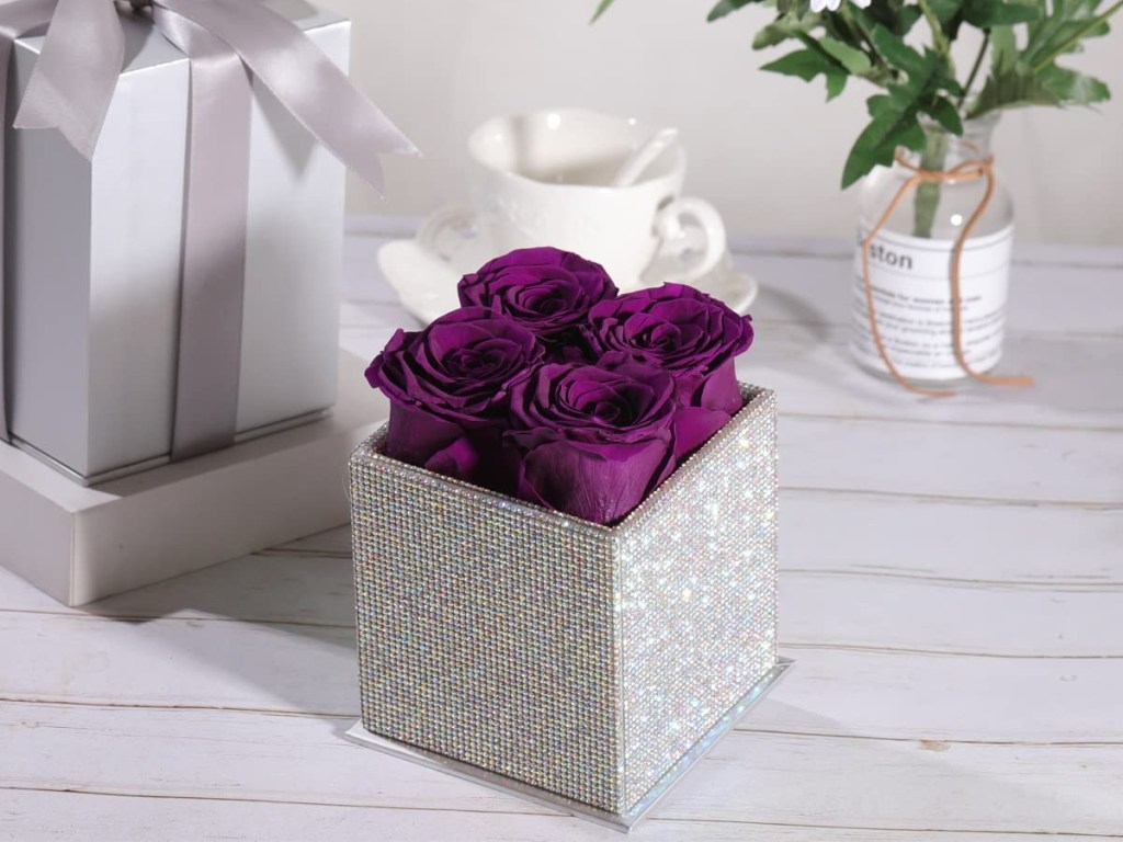 purple roses in a sparkly box
