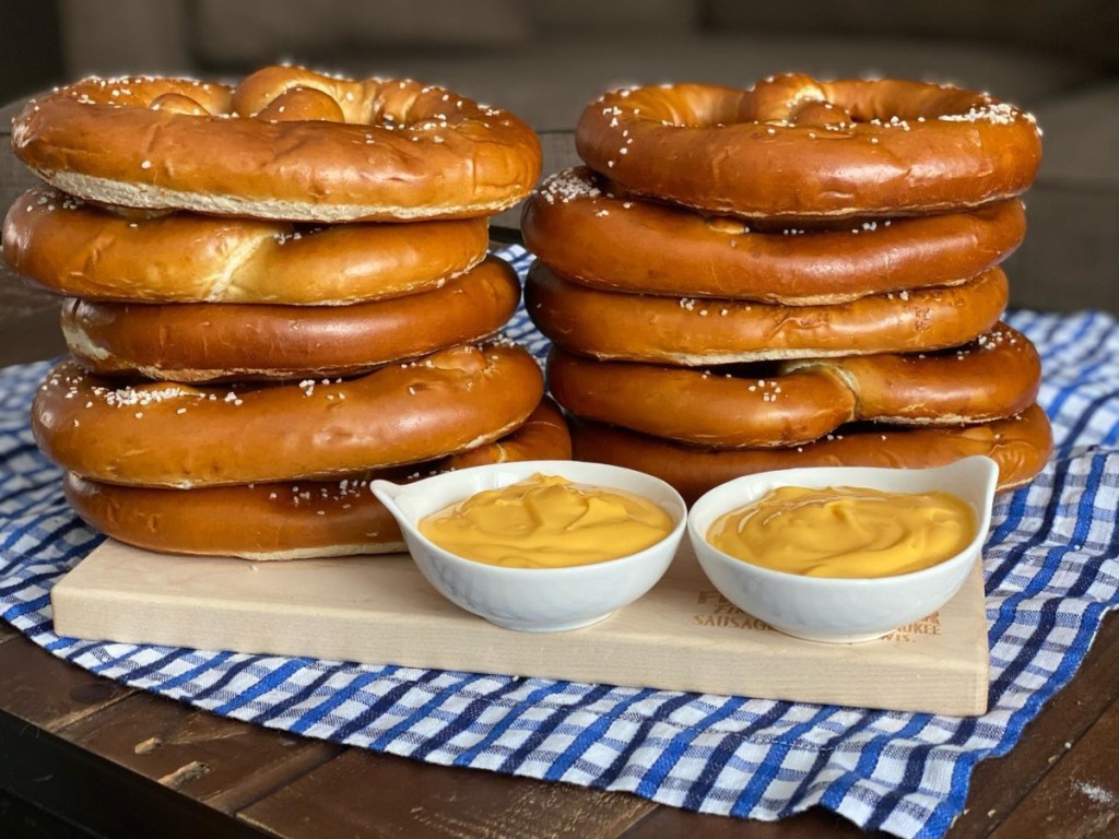 stacks of soft pretzels next to dipping sauces