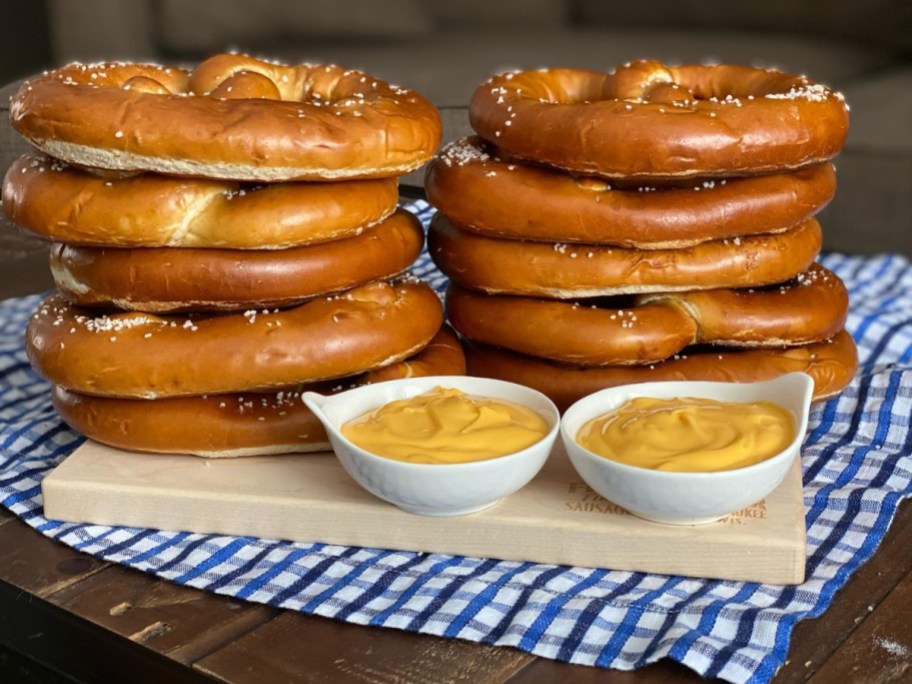 stacks of soft pretzels next to dipping sauces