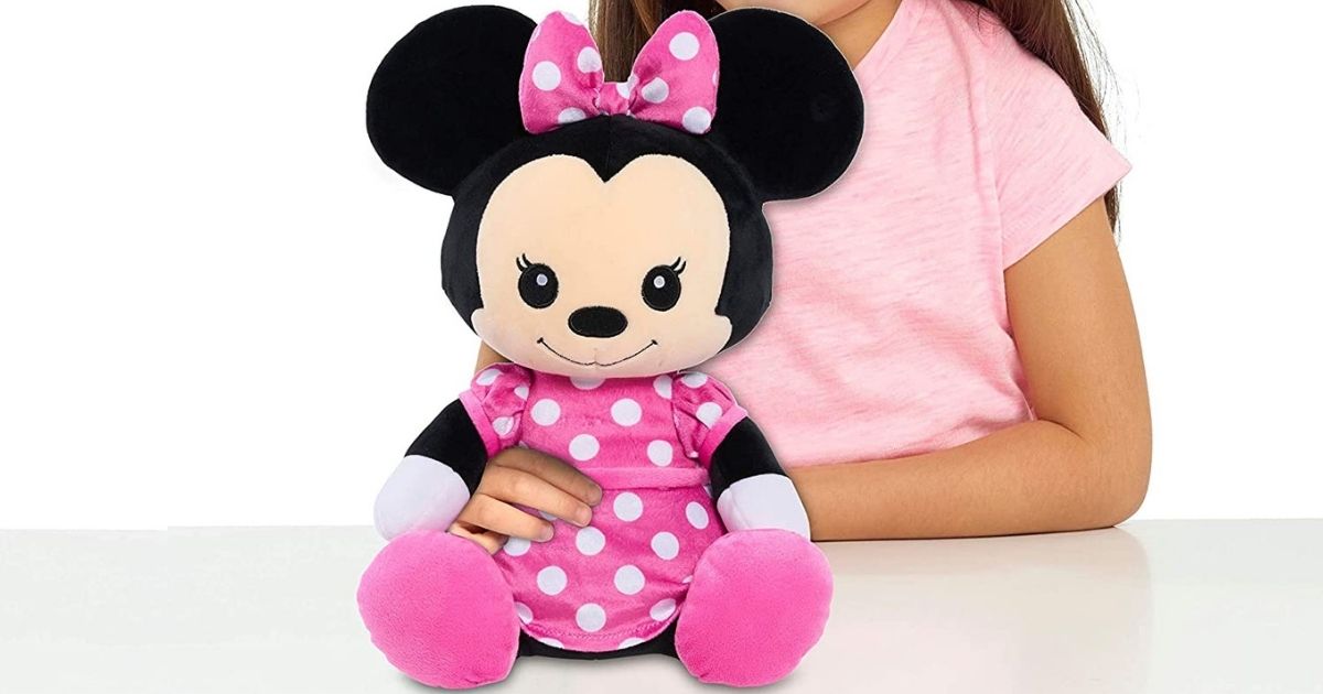 girl holding Minnie Mouse plush