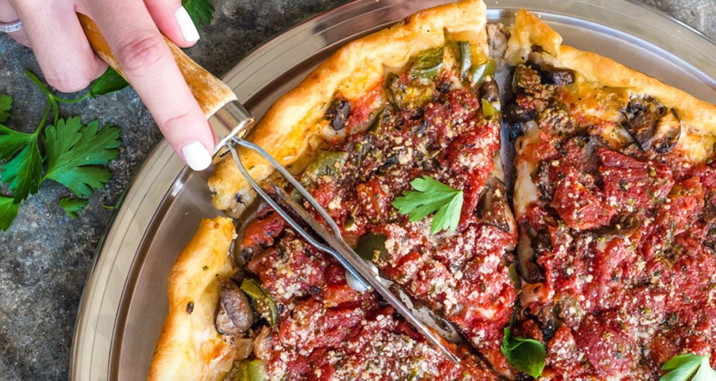 hand cutting deep dish chicago pizza from goldbelly