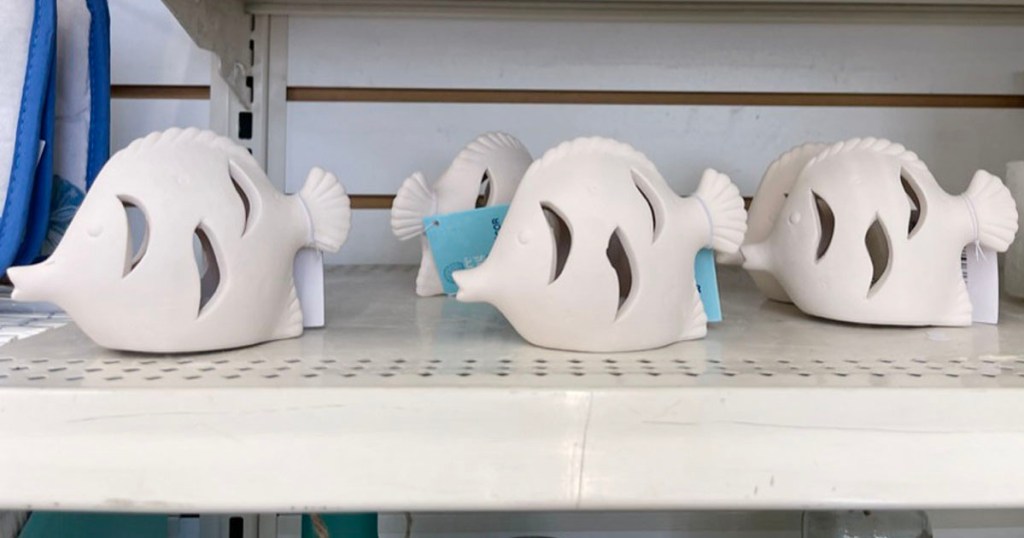 4 ceramic fish decor on shelf