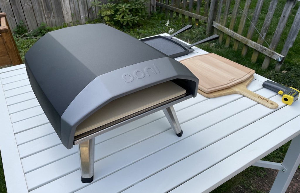 ooni pizza oven sitting on patio table outside