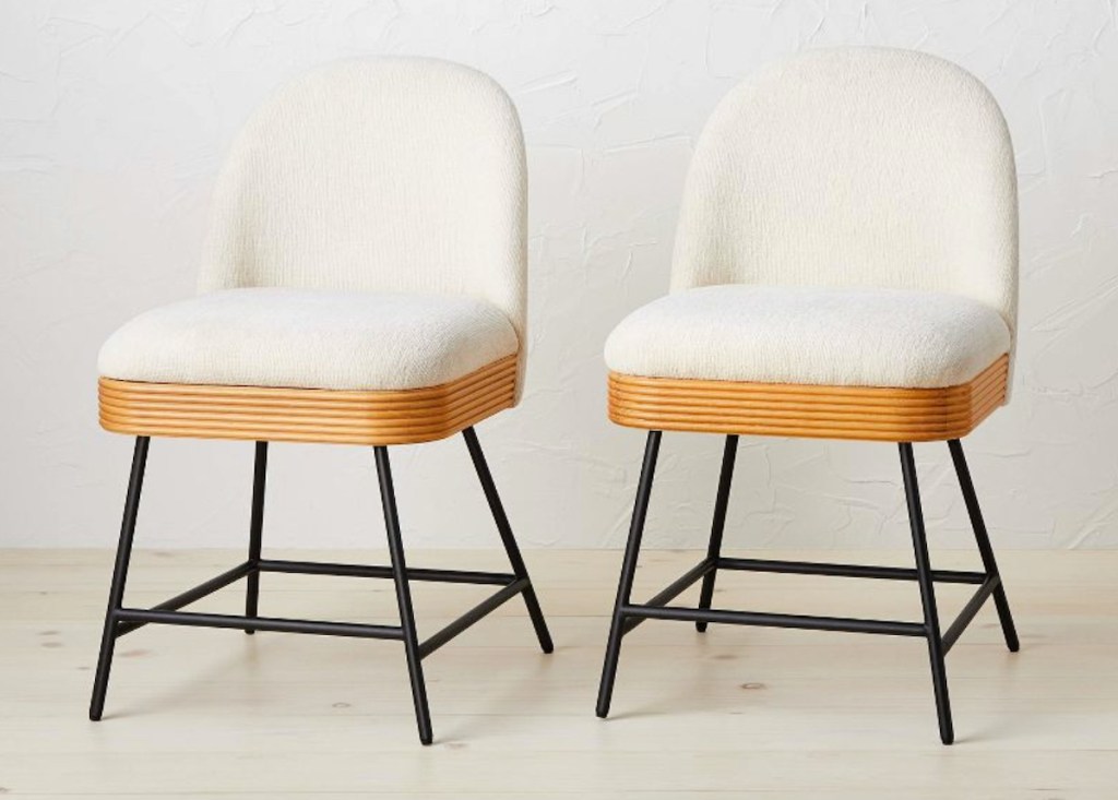 white rounded chairs with wood base and black legs
