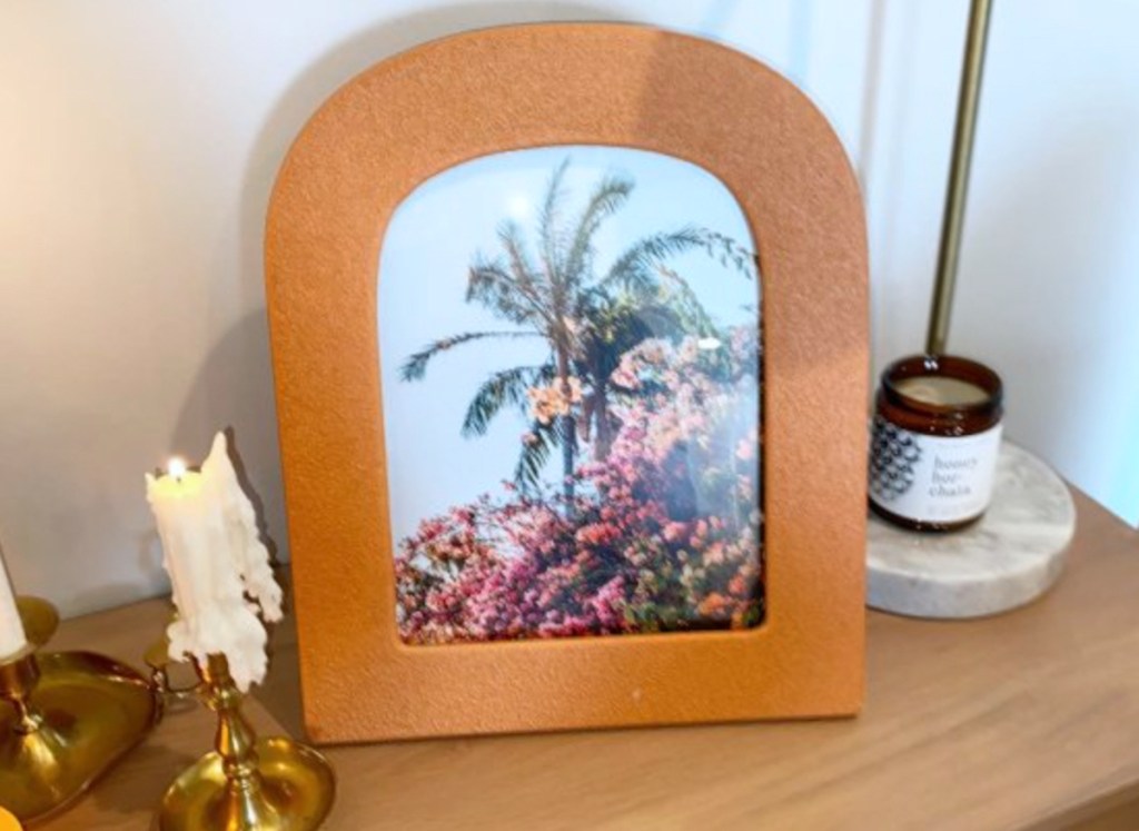 bubble frame with palm tree on table with melting candle