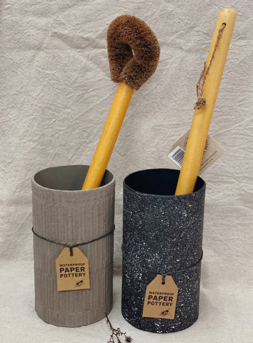 two paper pottery toilet bowl cleaners with wood handle brushes