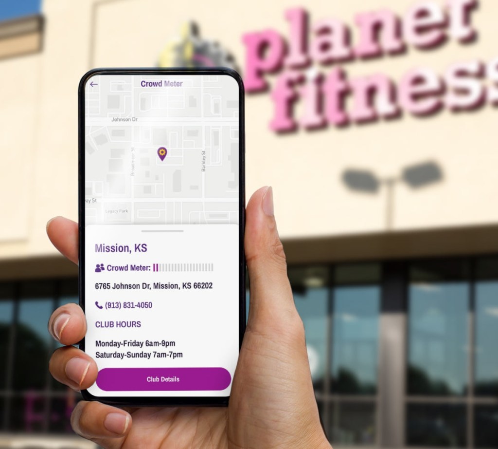 holding phone outside Planet Fitness gym
