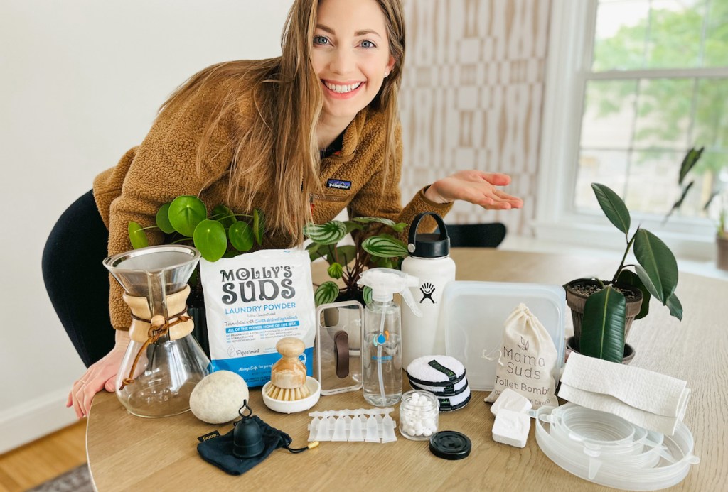 woman hovering over table full of reusable and eco friendly products earth day activities