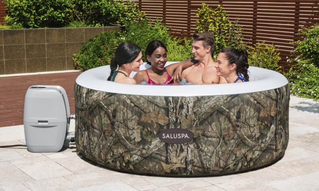 camouflage print inflatable hot tub with four people inside