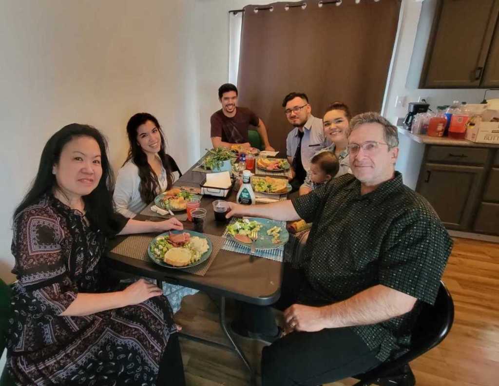 family sitting around table for easter dinner