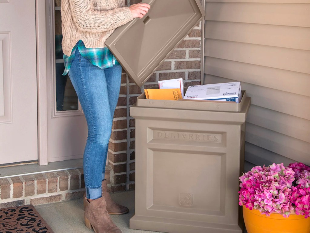 women taking mail out of delivery box