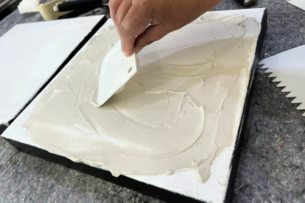 using a frosting spreader on textured canvas