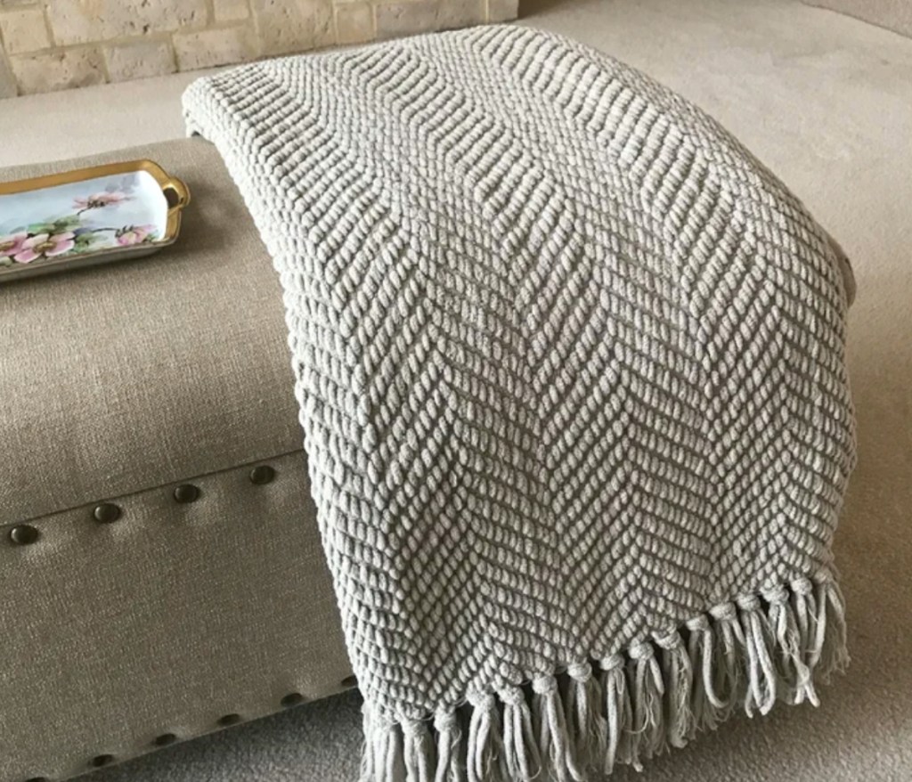 off white tweed throw blanket on couch
