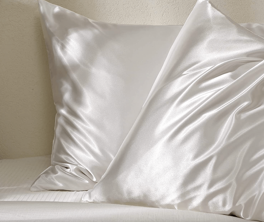 white satin pillowcases on bed 