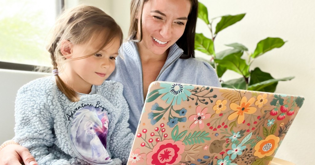 woman and daughter looking at laptop