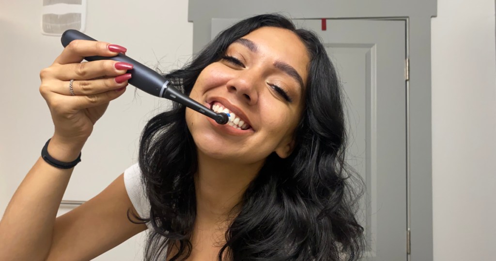 woman using oral b toothbrush