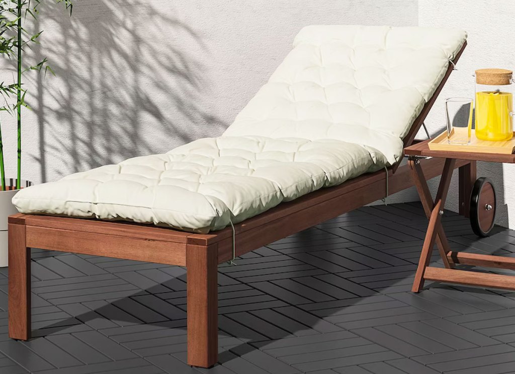 wood chaise lounge with white cushion