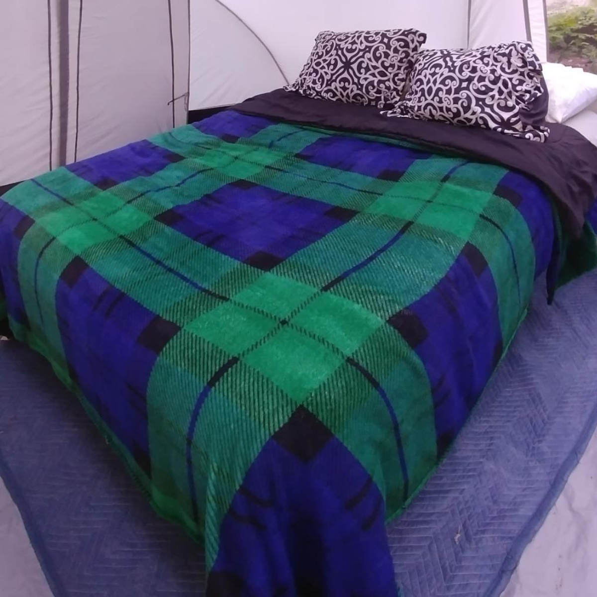 Air bed with bedding in tent