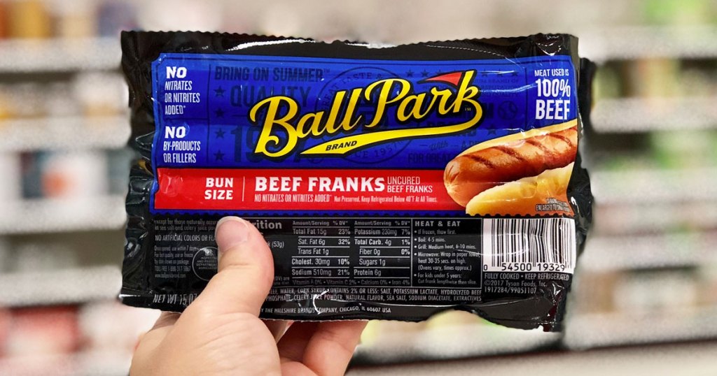 hand holding package of ball park beef franks