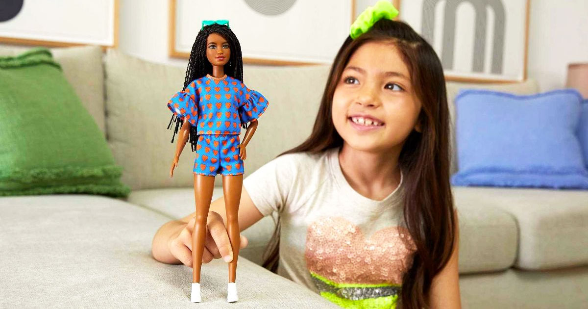 girl playing with Barbie Fashionista Doll