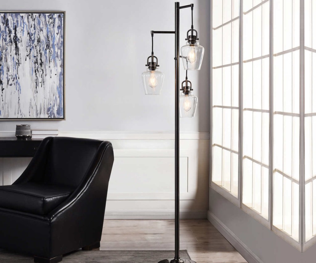 dark gray three-light floor lamp in home