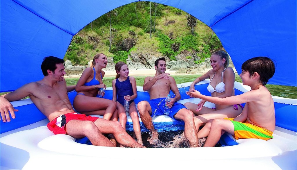 Family sitting on a Bestway Inflatable Island from Amazon