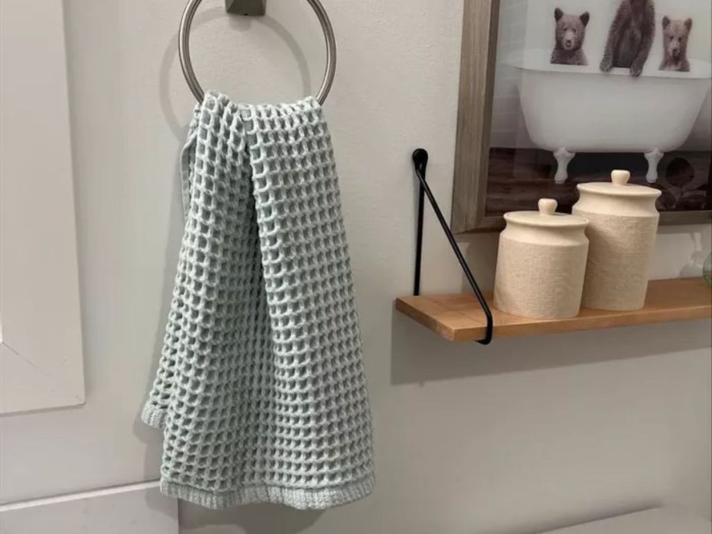 grey waffle hand towel on hook in bathroom