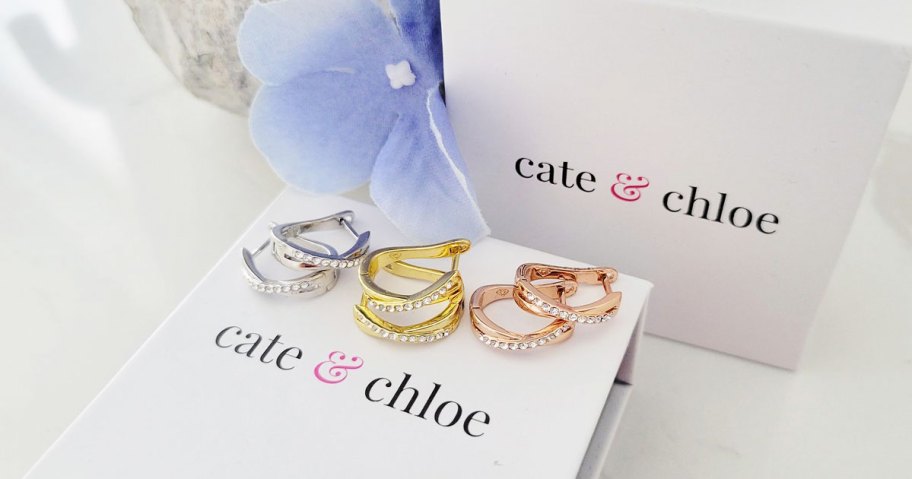 three pairs of cate & chloe earrings on top of a box