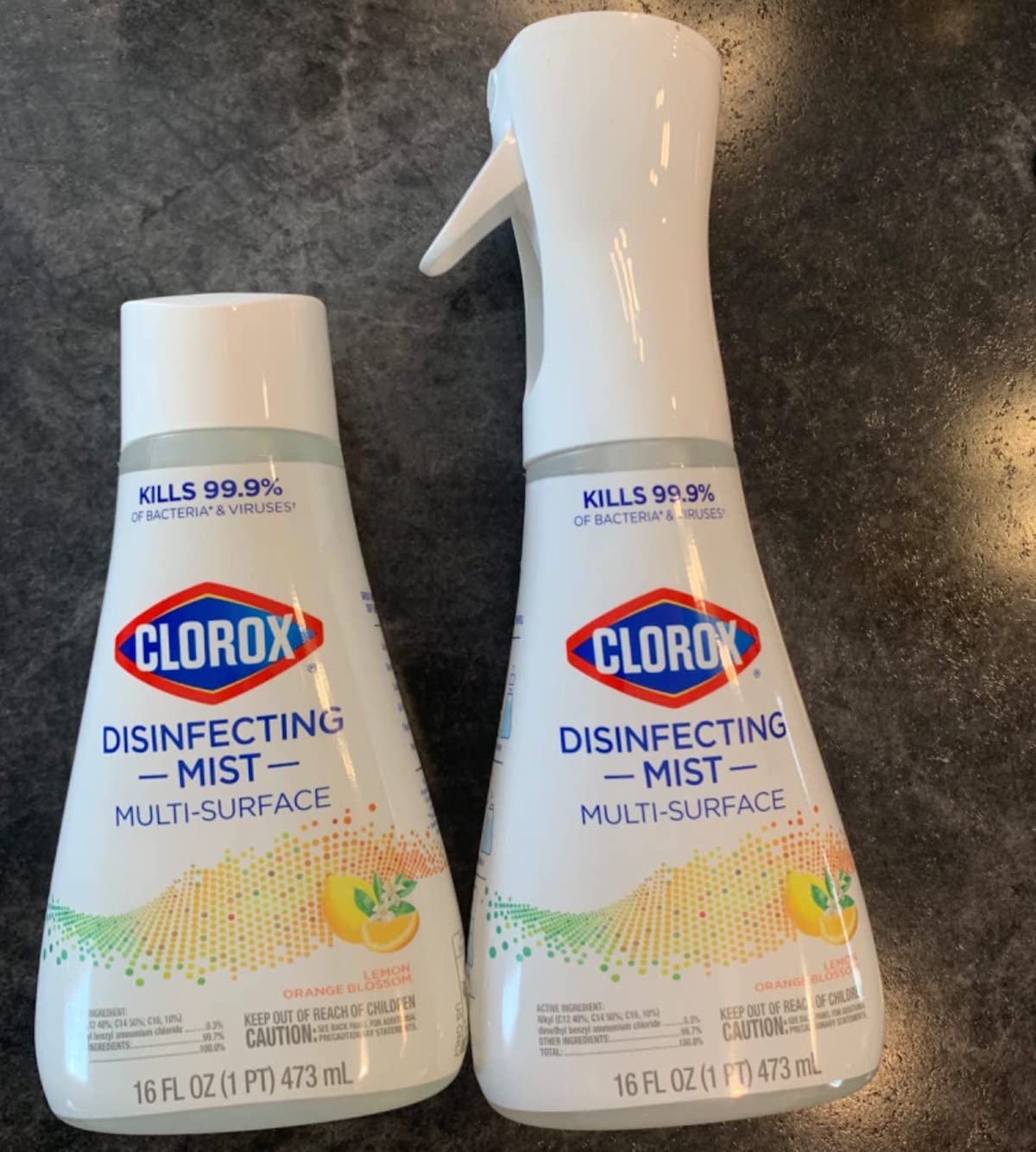 Clorox Disinfecting Mist spray and Refill bottle laying on a granite countertop