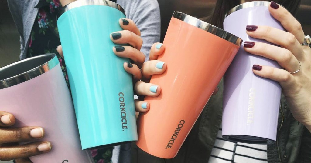 hands holding colorful corkcicle tumblers