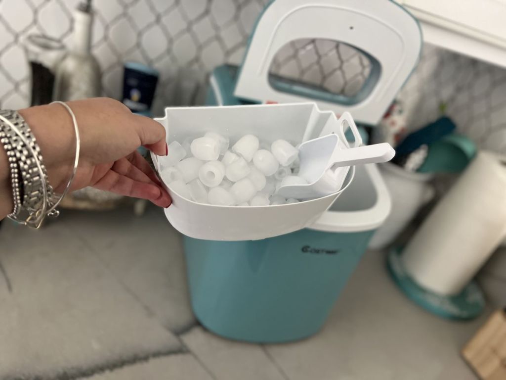 hand holding an ice basket from a Costway Ice Maker