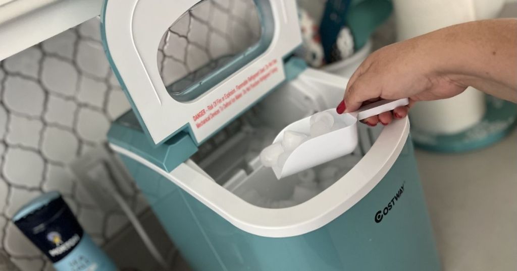 hand scooping ice out of a Costway ice maker