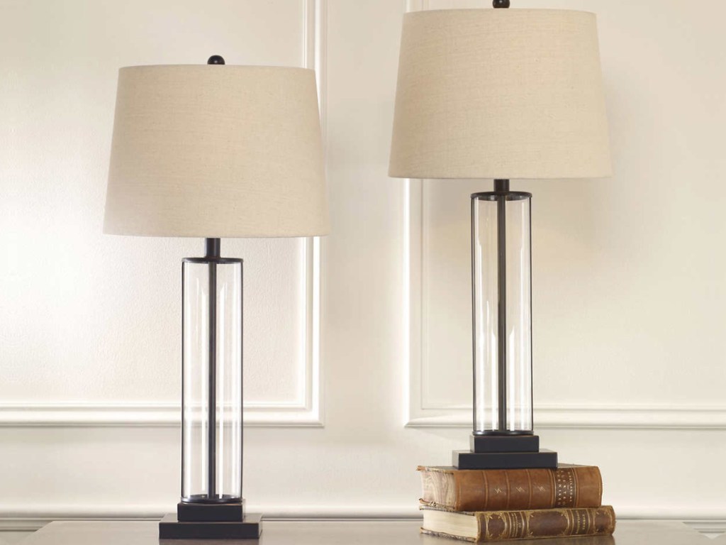 two glass table lamps on console table